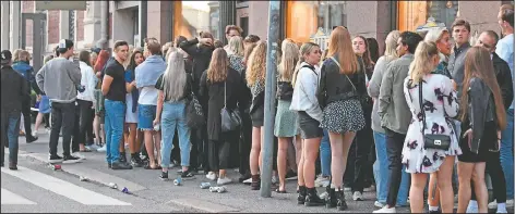  ?? (Lehtikuva/Jussi Nukari) ?? Young people queue up at a night club in Helsinki, Finland, on Wednesday. Finland lifted restrictio­ns in place to curb the spread of coronaviru­s with restaurant­s, bars and nightclubs opening from Monday.