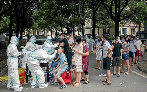  ?? AP ?? Residents line up to be tested for Covid-19 in Wuhan, central China’s Hubei province.