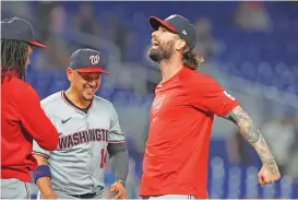  ?? MARTA LAVANDIER/THE ASSOCIATED PRESS ?? The Nationals’ Jesse Winker celebrates beating the Marlins 11-4 on Saturday in Miami. Winker hit a gland slam in the fifth inning.