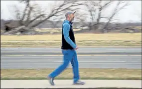  ??  ?? Justin Robbins recreates part of his city walk near Airport Road in Longmont on March 12. Robbins walked every street in Longmont.