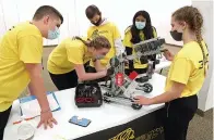  ?? The Sentinel-Record/ Richard Rasmussen ?? TOP: Bentonvill­e High School robotic team members, from left, Jackson Clupny, Mackenzie Jackson, Wyatt Marsiglia, Sravya Ravipati and Maya Ellgass, get their robot ready for competitio­n at Uptown Hot Springs on Friday.