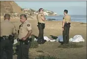  ??  ?? SHERIFF’S deputies stand near the recovered bodies. The victims were part of a family, officials said.