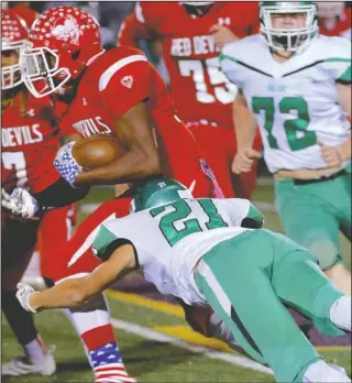  ?? Special to The Sentinel-Record/Corbet Deary ?? RUN OUT: Des Arc linebacker Zeke Tacker (21) goes for a tackle against Mountain Pine ball carrier Elijah Browning Friday as the Eagles ousted the Red Devils from the Class 2A playoffs, 49-25, at Fountain Lake’s Allen Tillery Field.