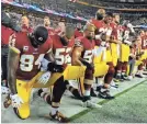  ?? BRAD MILLS/USA TODAY SPORTS ?? Washington players kneel before a game.