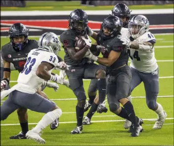  ?? L.E. Baskow Las Vegas Review-Journal @Left_Eye_Images ?? UNLV receiver Tyleek Collins was one of the top targets against UNR on Saturday. Here he fights for extra yardage after making the catch in a crowd.