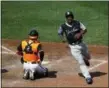  ?? PATRICK SEMANSKY — THE ASSOCIATED PRESS ?? New York Yankees’ Miguel Andujar, right, jogs past Baltimore Orioles catcher Austin Wynns after scoring on Luke Voit’s single in the fifth inning of a baseball game, Saturday in Baltimore.