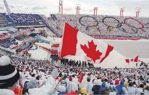  ?? AFP/GETTY IMAGES/FILES ?? Fans cheer the Canadian delegation at the opening ceremony of the Calgary Olympics in February 1988. Calgary’s bid to stage the 2026 Games suffered a crushing blow Tuesday, as residents voted overwhelmi­ngly against hosting it.