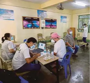  ?? EPA PIC ?? People waiting for their turn to receive the Sinovac vaccine at a high school used as a vaccinatio­n centre in Quezon City, Metro Manila on Tuesday.