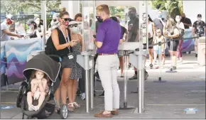  ?? John Raoux / AP ?? Guests enter SeaWorld as it reopens with new safety measures in place because of the coronaviru­s pandemic.