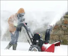  ?? AP PHOTO ?? Alex Martinez of Morristown, N.J., fights heavy winds as he uses a snowblower.