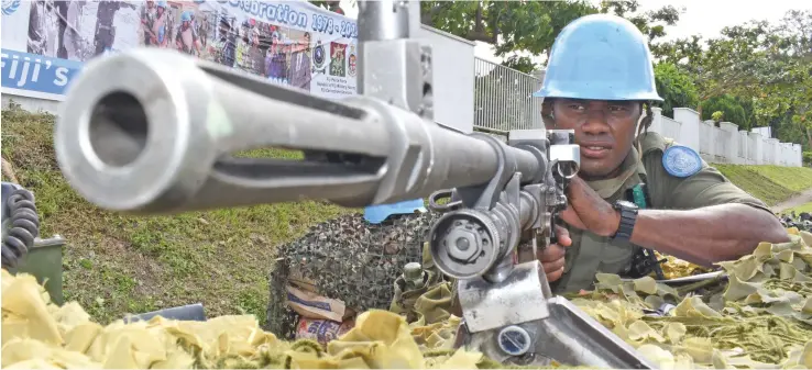  ?? Photo: Ronald Kumar ?? Private Setareki Tuivuna in a mock-up checkpoint at Vuya Road in Suva to mark Fiji’s 40th anniversar­y serving as UN peacekeepe­rs. The mock-up demonstrat­ion was held on June 14, 2018.