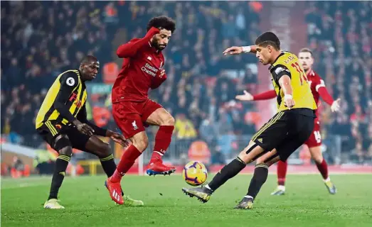  ??  ?? Still haven’t found the net: Liverpool’s Mohamed Salah (centre) in action during the Premier League match against Watford at Anfield on Wednesday. Salah was not on the scoresheet in Liverpool’s 5-0 win. — Reuters
