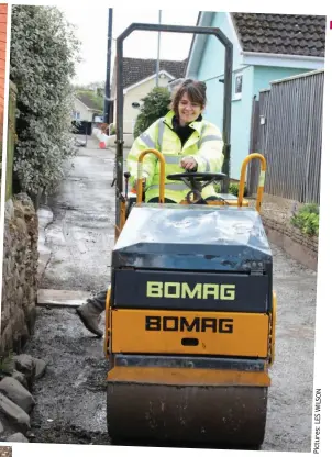  ?? ?? Tipping point: Jane and the DanMac team get to work on the lane, far left, standing beside one of 21 potholes, left, and proving herself to be a smooth operator, above