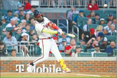  ?? Associated Press ?? Going yard: Atlanta Braves' Marcell Ozuna (20) hits a solo home run against the Boston Red Sox during the third inning of a baseball game Wednesday in Atlanta.