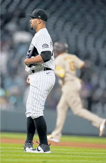 ?? David Zalubowski, The Associated Press ?? Rockies starting pitcher Antonio Senzatela waits after giving up a two-run home run to San Diego Padres’ Manny Machado, rear, during the fifth inning on Tuesday.