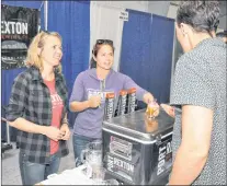  ?? KENN OLIVER/THE TELEGRAM ?? Port Rexton Brewing Co. owners Sonja Mills (left) and Alicia Macdonald were among 40 North American and European breweries represente­d at the Craft Beer Attraction this weekend at the St. John’s Curling Club. The Port Rexton team were debuting a new...