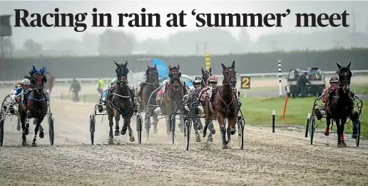  ?? AIMAN AMERUL MUNER/STUFF ?? Sonoma Tyron, driven by Gerard O’Reilly (red, second from right) wins race three at the Timaru Club’s summer meeting at Phar Lap Raceway on Saturday.