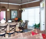  ??  ?? A large window brings abundant natural light into the breakfast area and kitchen.