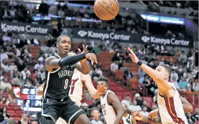  ?? USA Today Sports ?? HOT POTATO: Lonnie Walker IV, who had a game-high 22 points, fires a pass in the second quarter of the Nets’ 107-104 preseason victory over the Heat on Wednesday in Miami.