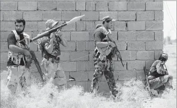  ?? Ahmad Al-Rubaye
AFP/Getty Images ?? MEMBERS of the Popular Mobilizati­on Units guard a position last week on the outskirts of Fallouja, another major Sunni-dominated city in the Euphrates River valley that the militants captured in January 2014.