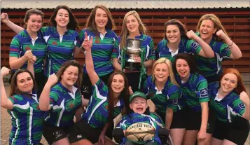  ??  ?? The Gorey Community School team, winners of the All-Ireland Schools sevens title, celebratin­g with their captain, Niamh Doran, and mentor, Matthew McGrath.