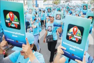  ?? PHA LINA ?? People living with HIV and their supporters march at a World AIDS Day gathering on Phnom Penh’s Koh Pich yesterday, to raise awareness of the disease in Cambodia.