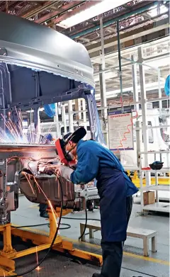  ??  ?? The heavy-duty trucks production line in the commercial automobile industrial park of Shaanxi Automobile Holding Group Co., Ltd.