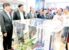  ??  ?? Chak (third left), Thien (fourth right), Chong (left) and Wong (second left) listening to a briefing by Twins Property on the property displayed at the KKOSPC Exhibition Hall in Sutera Avenue Commercial Plaza yesterday.