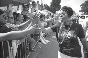  ?? Tom Fox/The Dallas Morning News via AP ?? ■ Then-new Dallas Police Chief U. Renee Hall greets those in the crowd Sept. 17, 2017, as she walks the length of the Texas Freedom Parade in Dallas. The Lakewood Brewing Alan Ross Texas Freedom Parade traveled southbound Cedar Springs from Wycliff to Turtle Creek Boulevard. For most Dallasites, the city’s LGBT history begins and ends in Oak Lawn, along Cedar Springs Road, where people march in parades and in protests.