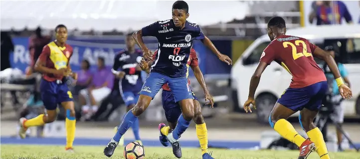  ??  ?? Shaniel Thomas (center) got himself on the score sheet for Jamaica College against St Andrew Technical High School in their ISSA/FLOW Manning Cup final at the National Stadium last night.