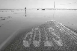  ?? ROBERT GAUTHIER/LOS ANGELES TIMES ?? Vehicles are submerged in floodwater­s on Ave. 56 near Central Valley Highway 43, a few miles north of Allenswort­h where residents fortified the levee protecting their neighborho­od.