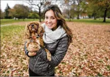  ?? ADAM CAIRNS/THE COLUMBUS DISPATCH ?? Ohio State University student Madeleine Entine and her therapy dog Cory.
