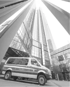  ??  ?? A police vehicle is parked at Deutsche Bank’s headquarte­rs in Frankfurt. — AFP photo