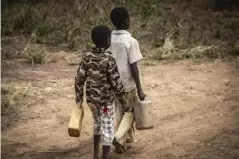  ??  ?? Children collecting water in Yambio, South Sudan
