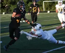  ??  ?? Bishop Foley receiver Jackson Zeiter (4) fends off a Shrine defender during Friday’s game at Bishop Foley. Zeiter had four touchdowns to lead the Ventures to a 42-20victory.