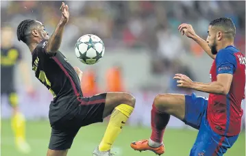  ?? AFP ?? Man City’s Raheem Sterling, left, vies with Steaua Bucharest’s Jugurtha Hamroun during the Champions League play-off first leg.