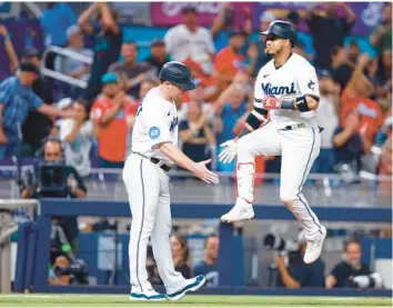  ?? MEGAN BRIGGS/GETTY ?? Jorge Soler rounds the bases and shakes hands with coach Griffin Benedict after hitting a home run against the Astros during the eighth inning at loanDepot park on Monday night in Miami.