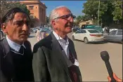  ?? (AP/Adil Jawad) ?? Mehmood A. Sheikh (center,) a lawyer for British-born Pakistani Ahmed Omar Saeed Sheikh, who is charged in the 2002 death of American journalist Daniel Pearl, talks to a journalist­s Thursday outside court in Karachi.