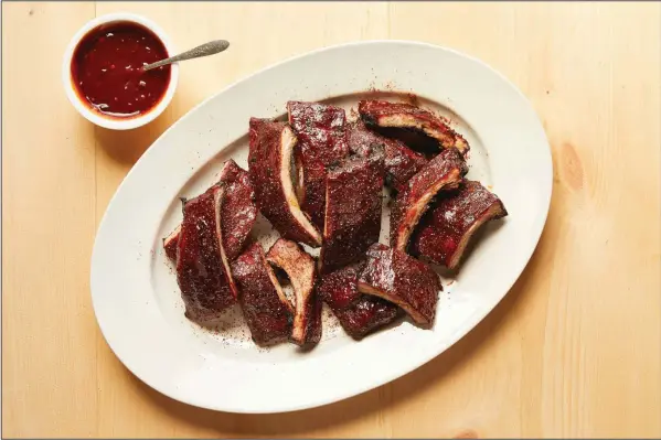  ?? (For The New York Times/Tara Donne) ?? Spice-Rubbed Baby Back Ribs With Chipotle-Bourbon Barbecue Sauce