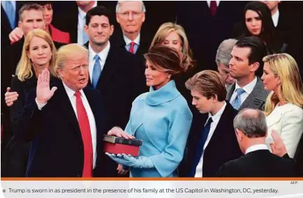  ?? AFP ?? Trump is sworn in as president in the presence of his family at the US Capitol in Washington, DC, yesterday.