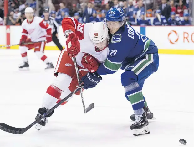  ?? —CP ?? Once a 30-goal scorer, Canucks winger Loui Eriksson concentrat­es on defence these days, as evidenced by this check on Detroit’ s Tyler Bertuzzi.