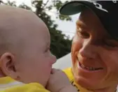  ?? CHRISTOPHE ENA/THE ASSOCIATED PRESS ?? Chris Froome celebrated his Tour de France victory on Sunday — first with a glass of champagne and then with his son Kellan. He finished at the back of the main pack in the final stage to win his third Tour title in four years.