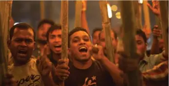  ?? ANUPAM NATH/THE ASSOCIATED PRESS ?? Activists of All Assam Minorities Students Union shout slogans during a torch protest on Saturday.