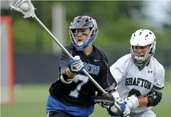 ?? STuART CAHILL / HeRALd sTAFF FILe ?? ALMOST TIME: Dover-Sherborn’s Alexander Thompson, left, moves around Grafton’s Jack Gurney during the Div. 3 final at Babson College on June 21, 2019.