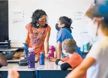  ?? MATT ROURKE/AP ?? Student teacher Olivia Vazquez, left, is finishing up her degree. The 27-year-old hopes that immigrant students arriving in Philadelph­ia have a more supportive experience than she did.