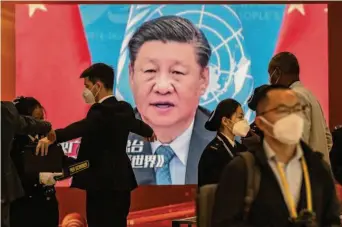  ?? Kevin Frayer/Getty Images ?? An image of Chinese President Xi Jinping is broadcast at a press center security checkpoint for the 20th National Congress of the Communist Party of China, which will formally open Sunday.