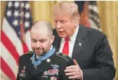  ?? PABLO MARTINEZ MONSIVAIS/AP ?? President Donald Trump leans in after presenting the Medal of Honor to former Army Staff Sgt. Ronald J. Shurer II on Monday.