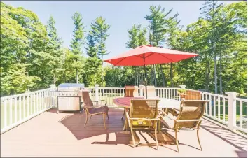  ?? Berkshire Hathaway HomeServic­es New England Properties ?? Above: A spacious deck provides splendid views of the expansive property at 21 Taunton Lane in Newtown. Below: The profession­ally landscaped property has exquisite stone work found in the front walkway and porch area, patio, and walls around the yard.