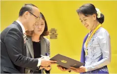  ?? — AFP photo ?? File photo shows Suu Kyi (right) receiving the Gwangju Prize for Human Rights in the southweste­rn city of Gwangju.