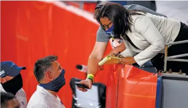  ?? AP ?? Sideline reporters such as Lisa Salters, interviewi­ng Titans coach Mike Vrabel, became grandstand reporters.